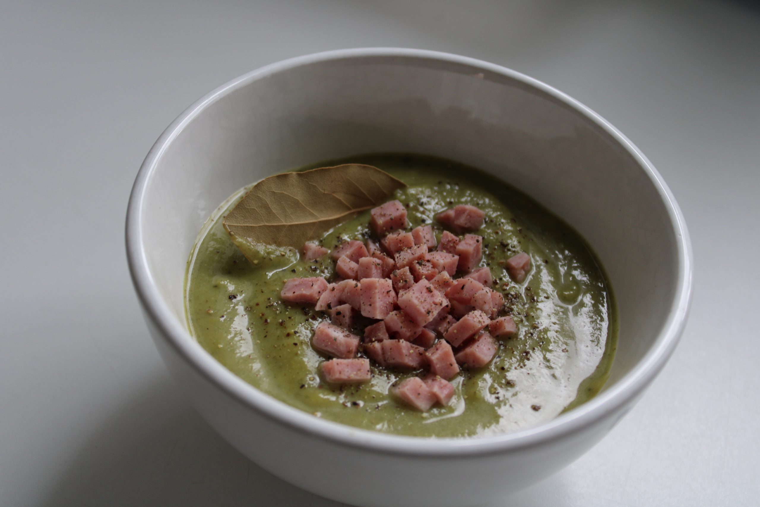 Broccoli soup finished with ham cubes